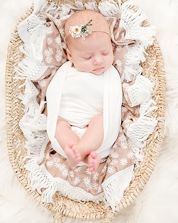 Baby posed in a basket and swaddled with First Landings swaddle blankets