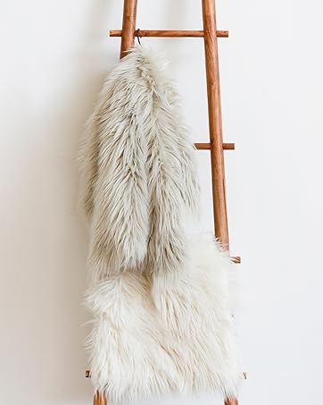 Faux Furs posed on a blanket ladder