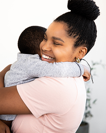 Mom hugging young child