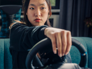 a woman driving g923 racing wheel for playstation